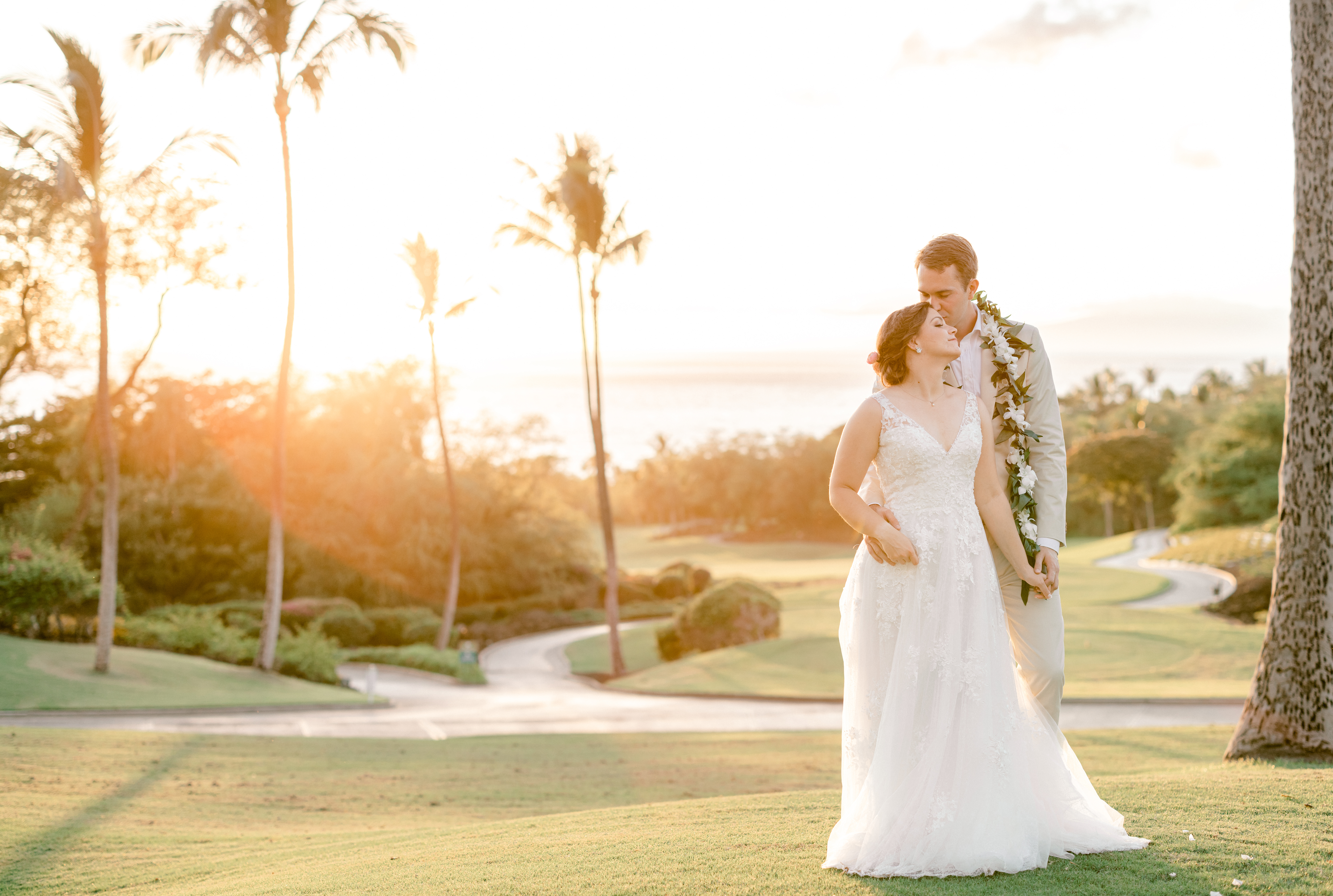 Newlyweds standing together during a Maui sunset at Gannon's restaurant