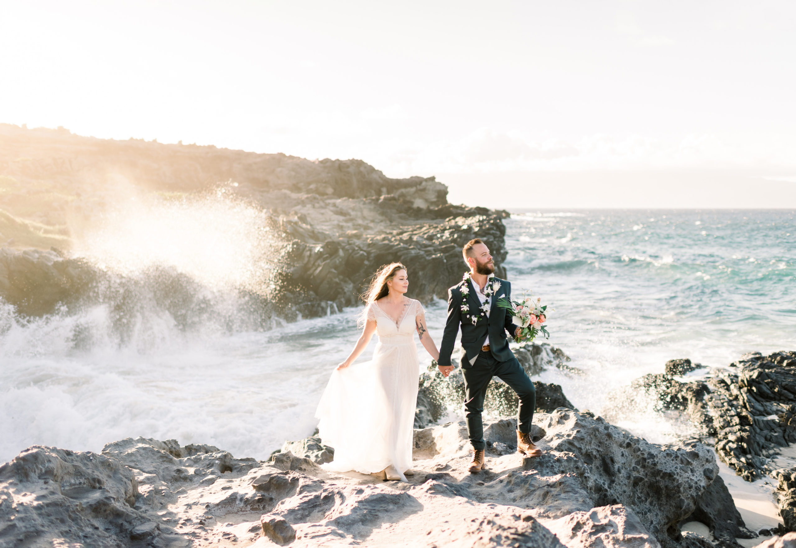 West Maui Elopement Images of husband and wife standing side by side on lava rocks holding hands