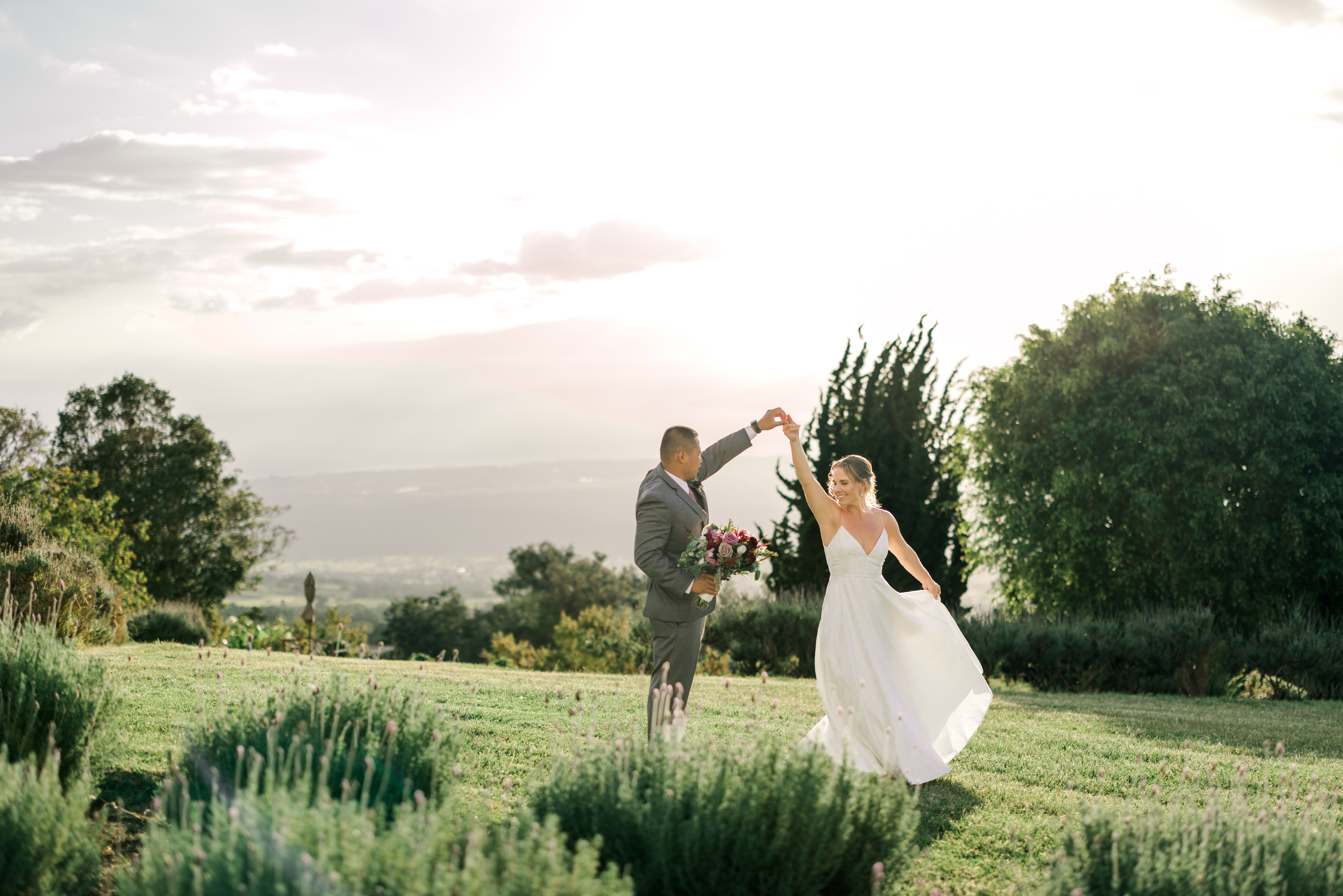 Newlyweds holding hands at Kula Lavender Farm in Maui