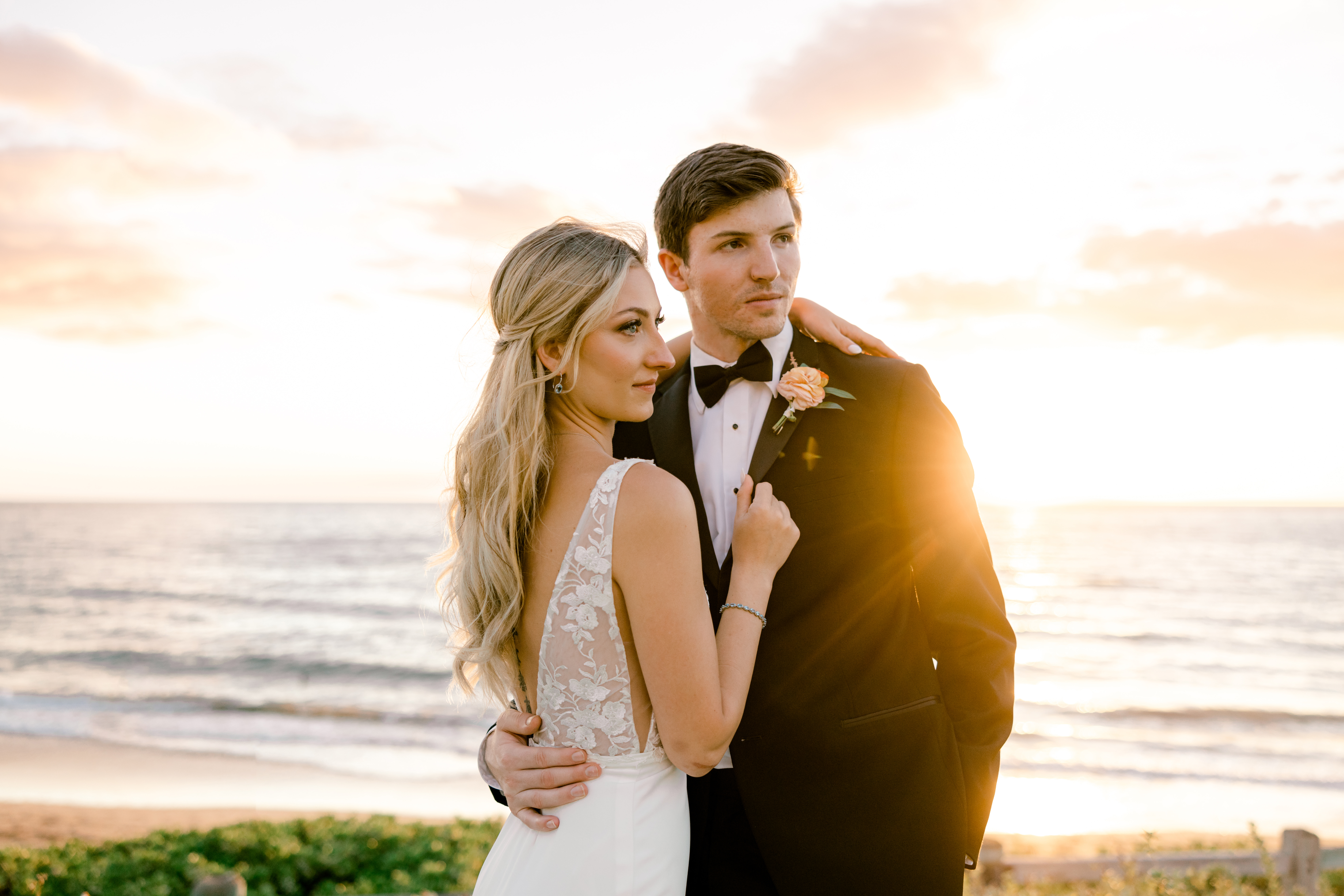 Newlyweds holding each other during sunset at the Maui Andaz Resort in Wailea.
