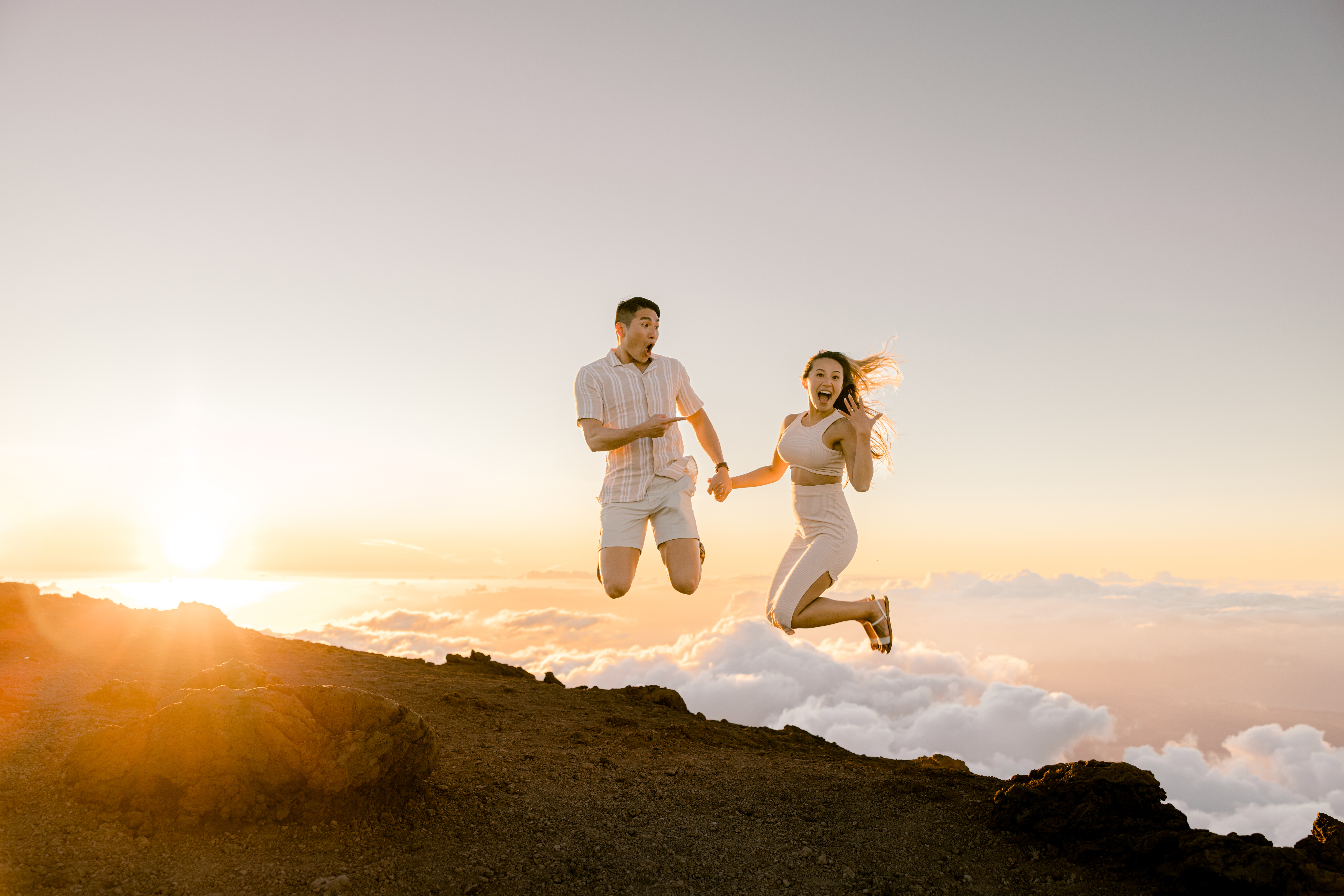 Engagement Portrait of Woman and Man jumping on top of a Haleakala volcano in Maui